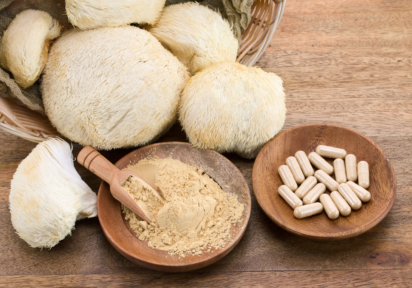 Fresh Lion's Mane mushrooms alongside mushroom powder and capsules